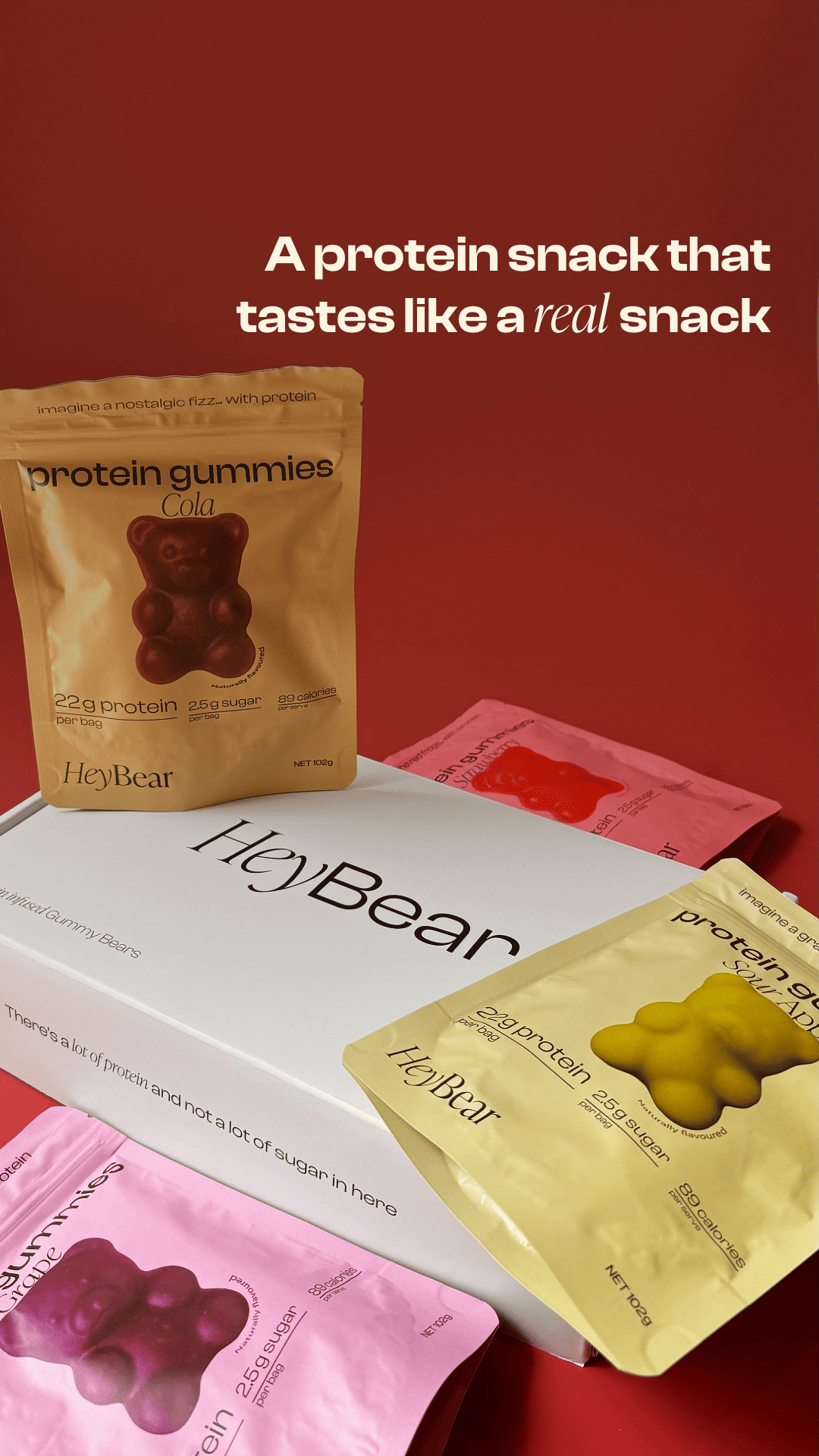 Protein gummy bear packaging with 'HeyBear' branding on a red background.